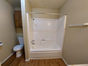 Marble Falls apartment for rent - A white bathroom with a toilet, sink, and bathtub.