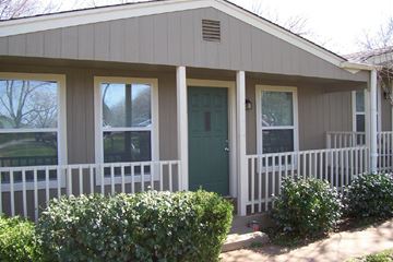 Marble Falls apartment for rent - A small house with a green door and white fence.