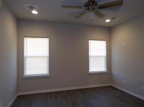 Marble Falls apartment for rent - a empty room with a ceiling fan and two windows