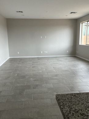 Surprise house for rent - a empty living room with a tile floor