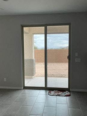 Surprise house for rent - an empty living room with a sliding glass door