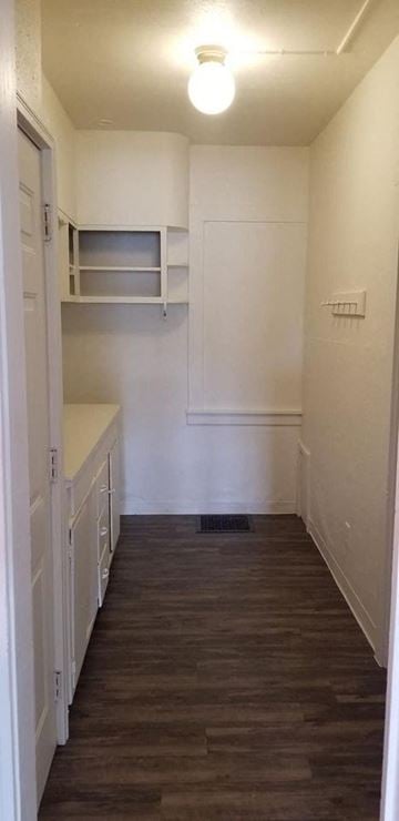 Warren apartment for rent - a small kitchen with a wood floor and white cabinets