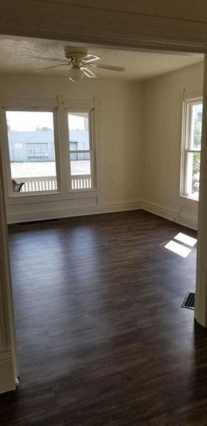 Warren apartment for rent - an empty living room with wooden floors and a ceiling fan