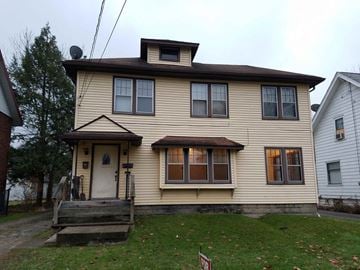 Warren apartment for rent - A two-story house with a brown roof and a white door.