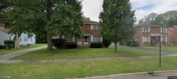 Warren house for rent - a house on a street with trees in front of it