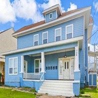 Dallas apartment for rent - A blue house with white trim and a white door.