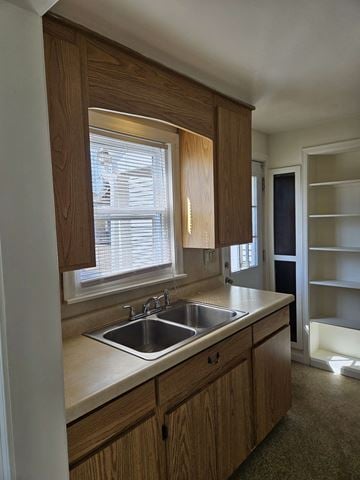Warren house for rent - A kitchen with wooden cabinets and a window above the sink.