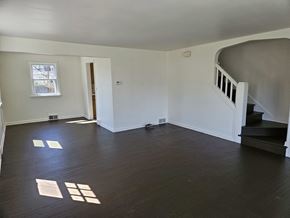 Warren house for rent - A room with wooden floors and a staircase.