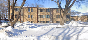 Fargo apartment for rent - A large building with a parking lot in front of it.