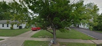 Warren house for rent - a red car driving down a street next to a tree
