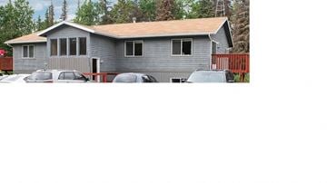 Kenai apartment for rent - a house with cars parked in a parking lot