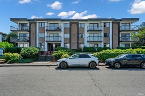 Burnaby apartment for rent - Two cars parked in front of a modern apartment building.