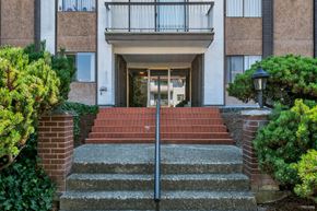 Burnaby apartment for rent - A building with a red brick staircase leading to the entrance.