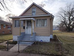 Gary house for rent - A small house with a front porch and a fence.