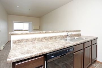 North Sioux City apartment for rent - a kitchen with granite counter tops and a dishwasher and sink