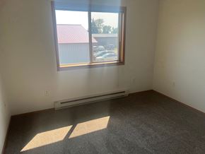 Detroit Lakes apartment for rent - A room with a window and a radiator on the wall.