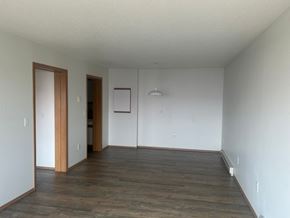 Detroit Lakes apartment for rent - A room with wooden floors and white walls.