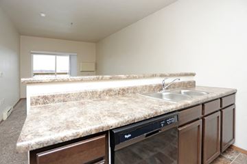 North Sioux City apartment for rent - a kitchen with granite counter tops and a dishwasher and sink