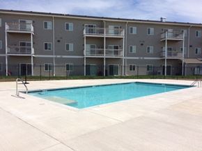 North Sioux City apartment for rent - a swimming pool in front of an apartment building