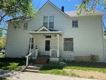 Bozeman apartment for rent - a white house with a front porch and steps