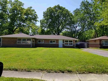 Youngstown house for rent - the front of a house with a lawn and trees