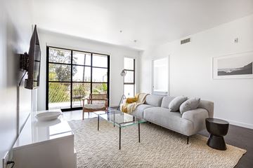 Los Angeles apartment for rent - a living room with a gray couch and a glass coffee table