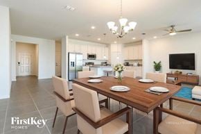 Kissimmee house for rent - A dining room with a wooden table and chairs.