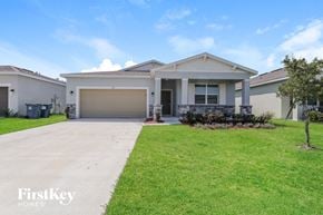 Bartow house for rent - a house with a driveway and a garage door