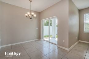 Bartow house for rent - a formal living room with a sliding glass door to a patio