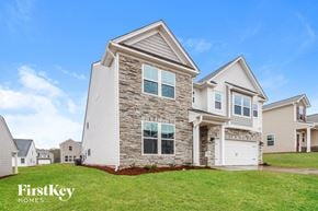 Greer house for rent - a home with a stone exterior and white siding