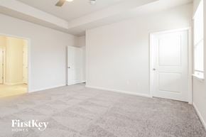 Greer house for rent - a bedroom with a carpeted floor and white doors