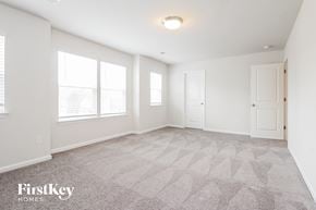 Greer house for rent - a spacious living room with a carpeted floor and white walls