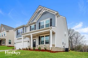 Greer house for rent - A modern house with a grey and white exterior and a large front porch.