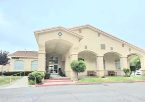 Wildomar multi-family for rent - A building with a beige facade and a red roof.
