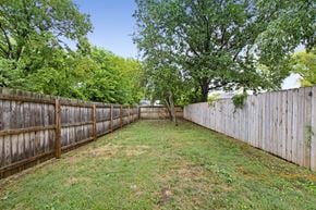 Nashville house for rent - a backyard with a wooden fence and a tree