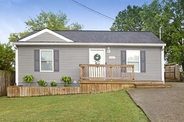 Nashville house for rent - the exterior of a gray house with a deck and a porch