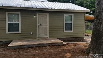 San Antonio apartment for rent - a small green house with a porch and a door