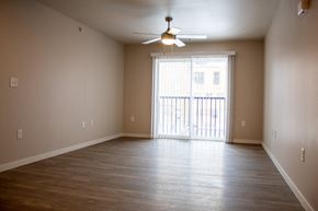 Jamestown apartment for rent - an empty living room with wood floors and a ceiling fan