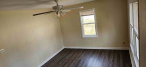 Clinton house for rent - A room with a ceiling fan and a window.