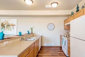 Ellensburg apartment for rent - a kitchen with a white refrigerator freezer next to a stove top oven