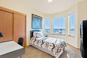 Ellensburg apartment for rent - a bedroom with a bed and four windows