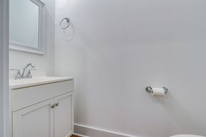 Chapel Hill house for rent - A white bathroom with a sink and a roll of toilet paper on the wall.