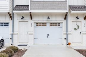 Chapel Hill house for rent - A white house with a garage door and a car parked outside.