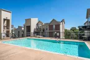 Nashville apartment for rent - A swimming pool in front of apartment buildings.