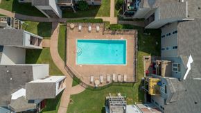 Nashville apartment for rent - A swimming pool surrounded by a concrete patio and a grassy area.