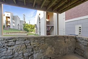 Nashville apartment for rent - A stone wall with a building in the background.