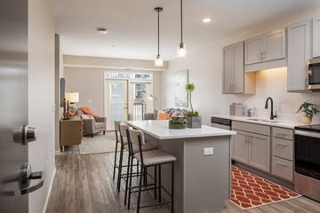 Burnsville apartment for rent - A modern kitchen with a dining table and chairs.