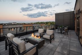 Burnsville apartment for rent - A patio with a fire pit and chairs.
