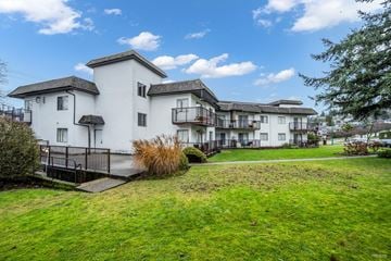 Burnaby apartment for rent - A white building with a black railing in front of it.