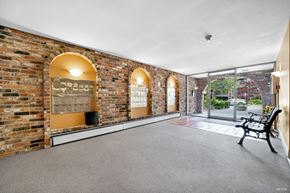 White Rock apartment for rent - A room with brick walls and a bench.